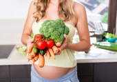 Donna incinta che mangia verdure